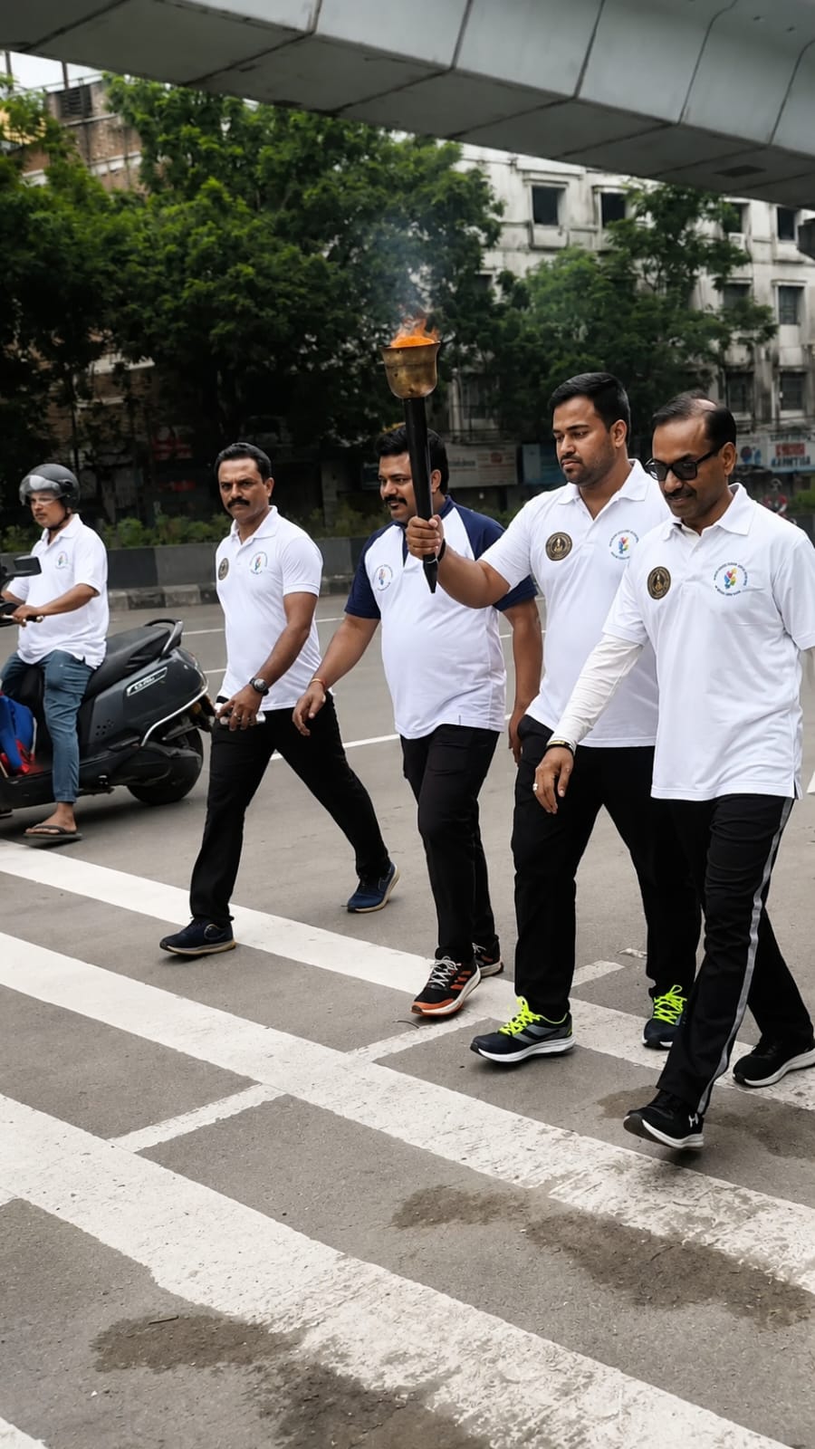 Ganghan coaches carrying the torch at the Telangana Olympic Day Run, Hyderabad
